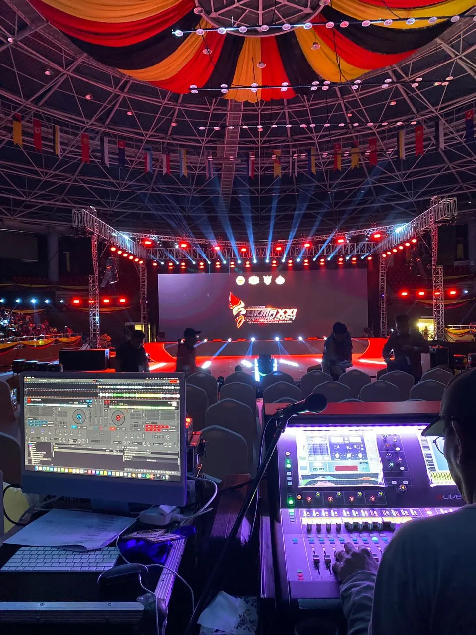 SUKMA XXI Sarawak 2024 opening ceremony stage with a lighting truss and a live sound mixing console in the foreground
